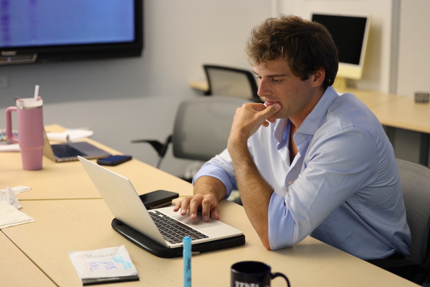 Tate working at a laptop during a client session
